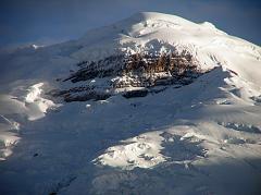 Ecuador Cotopaxi 02-13 Cotopaxi From Tambopaxi At Sunset Close Up Here is a close up of Cotopaxi�s north face seen from Tambopaxi near sunset. The enormous black rock amidst the white snow is called, 